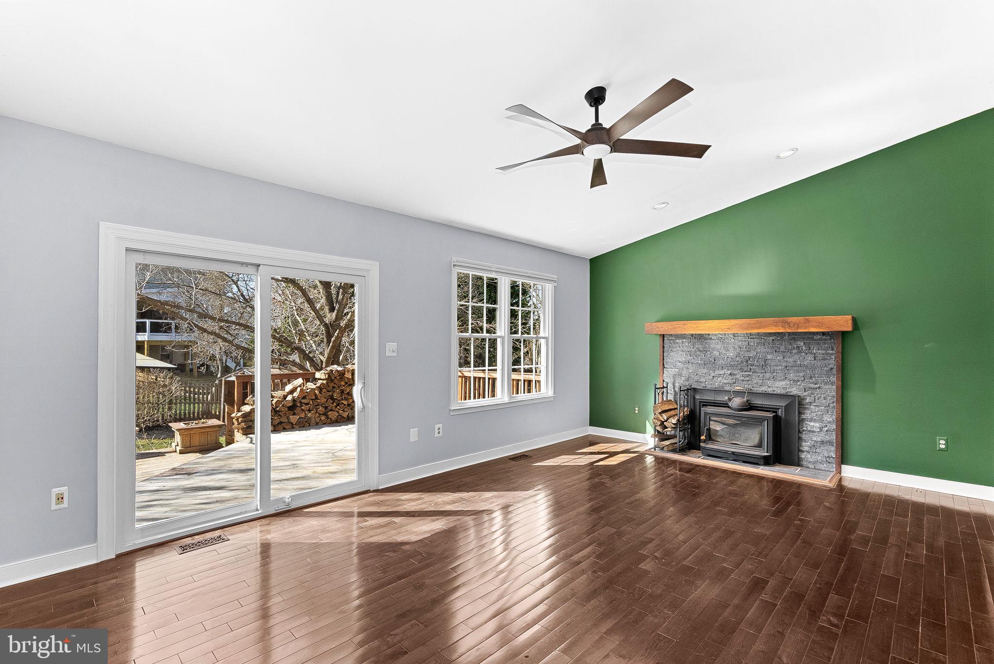 105 Country Road Sterling, VA 20165 - Photo 18 of 49 a view of a livingroom with a fireplace wooden floor and windows