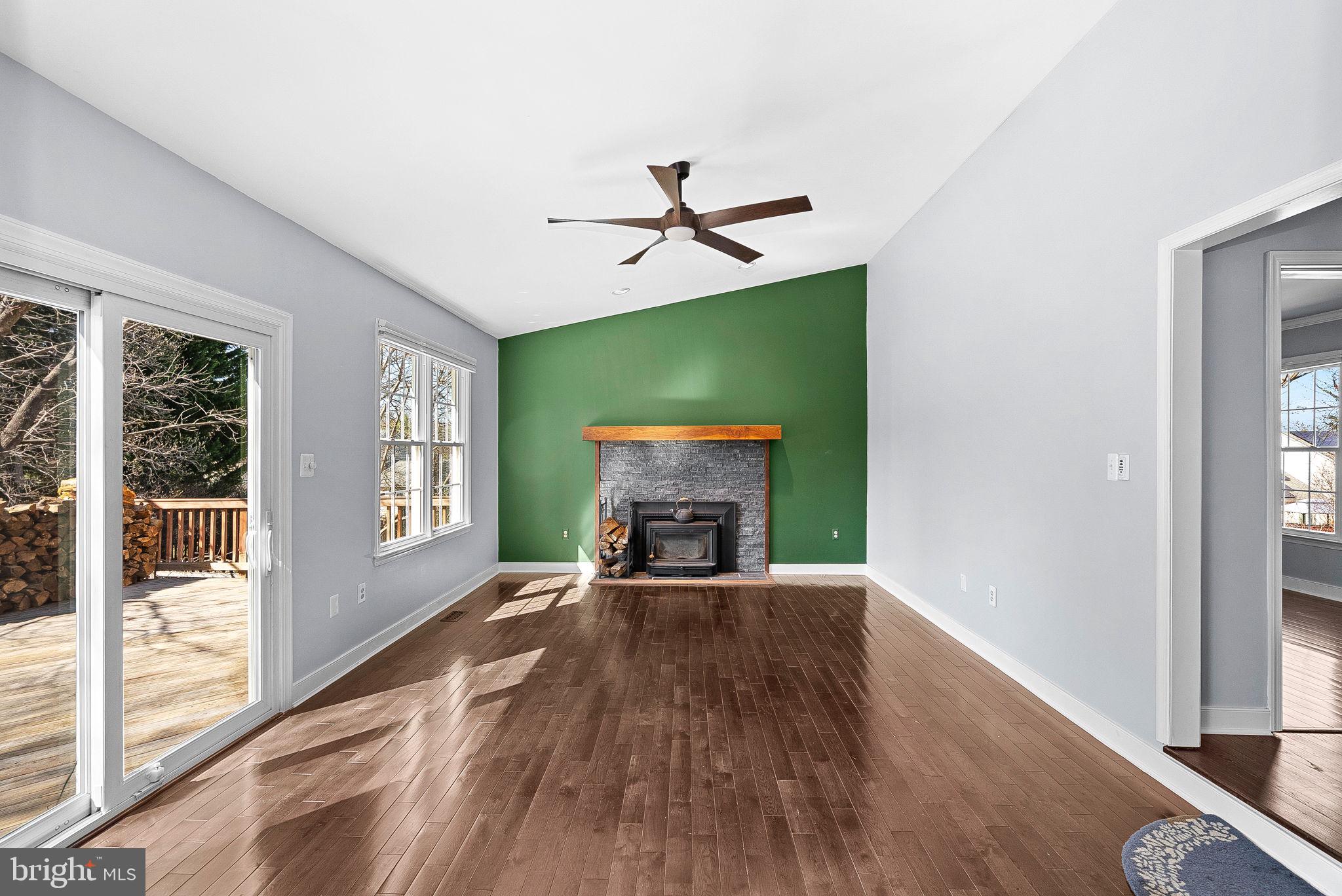 105 Country Road Sterling, VA 20165 - Photo 19 of 49 wooden floor fireplace and windows in an empty room