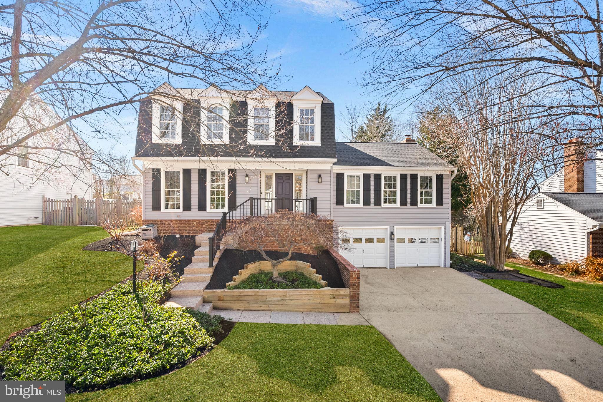 105 Country Road Sterling, VA 20165 - Photo 2 of 49 a front view of a house with garden
