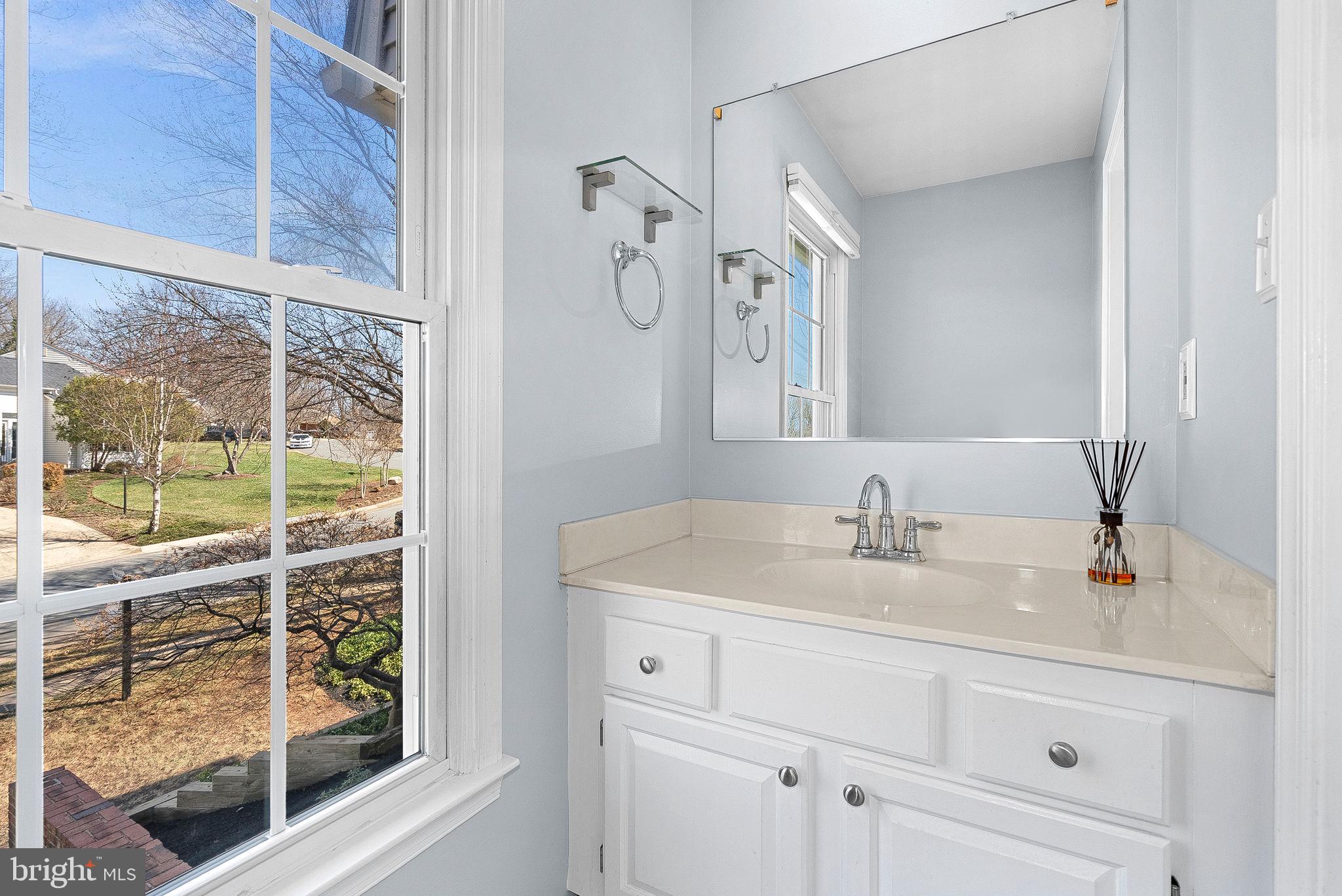 105 Country Road Sterling, VA 20165 - Photo 21 of 49 a bathroom with a granite countertop sink and a mirror
