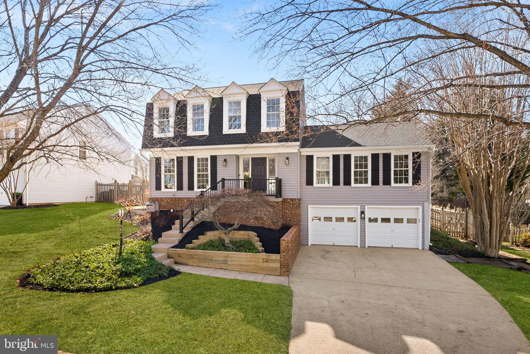 105 Country Road Sterling, VA 20165 - Photo 46 of 49 a front view of a house with a garden