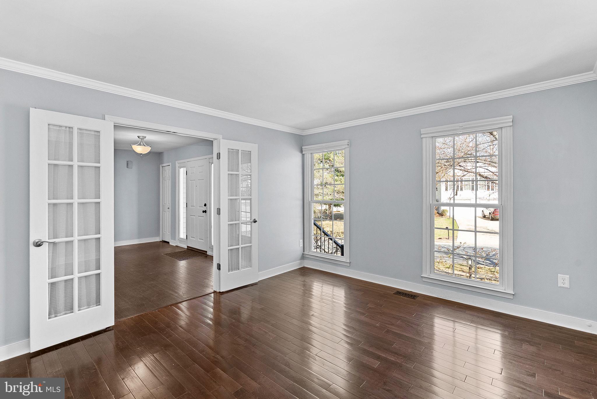 105 Country Road Sterling, VA 20165 - Photo 6 of 49 a view of an empty room with wooden floor and a window