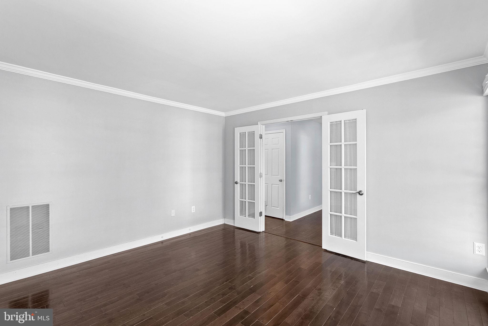 105 Country Road Sterling, VA 20165 - Photo 7 of 49 a view of an empty room with wooden floor and a window