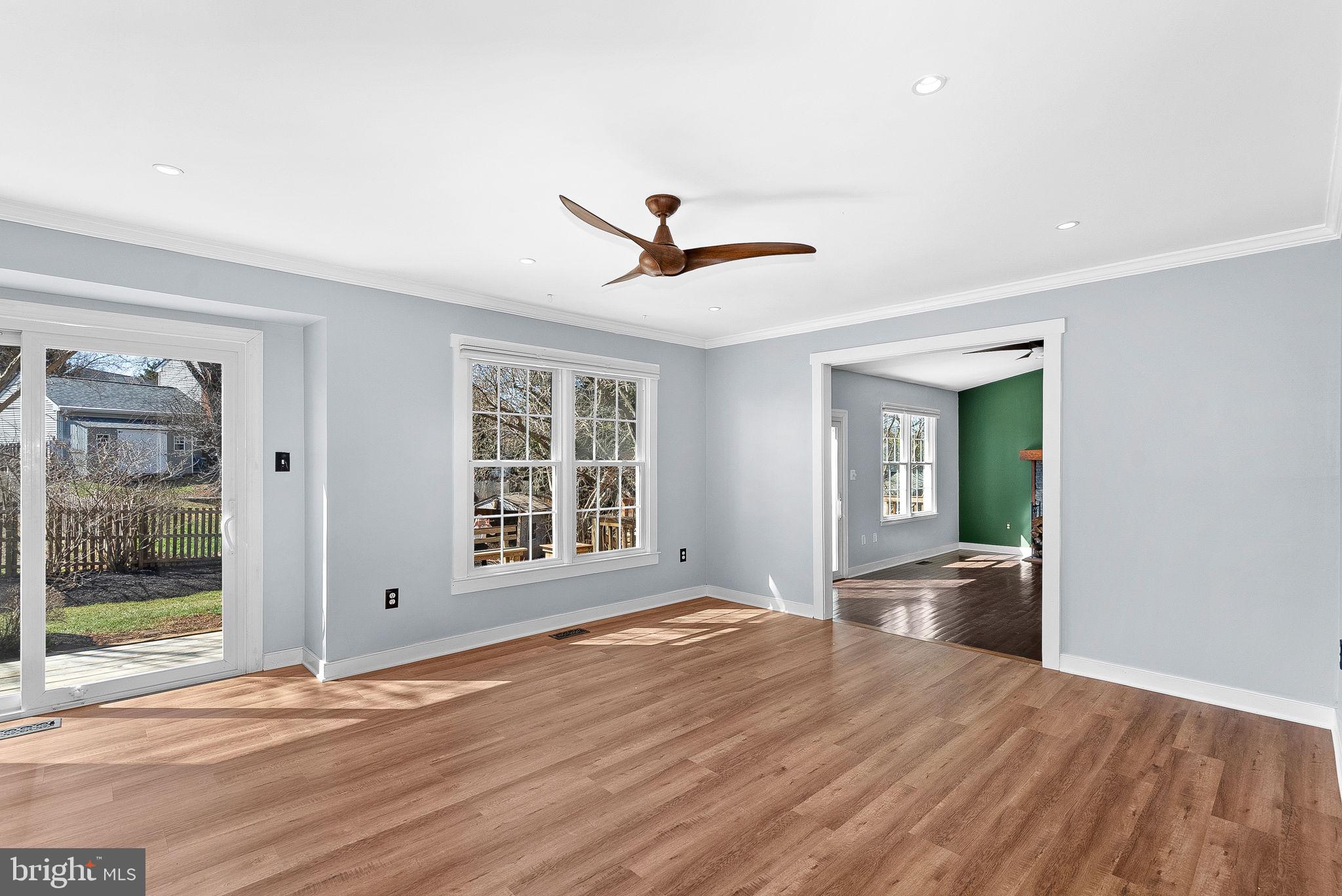 105 Country Road Sterling, VA 20165 - Photo 10 of 49 a view of a livingroom with wooden floor and a ceiling fan