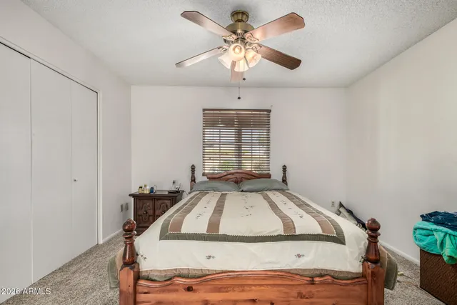a view of a bedroom with bed and window