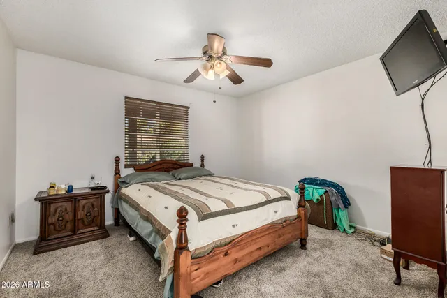 a bed sitting in a bedroom next to a window
