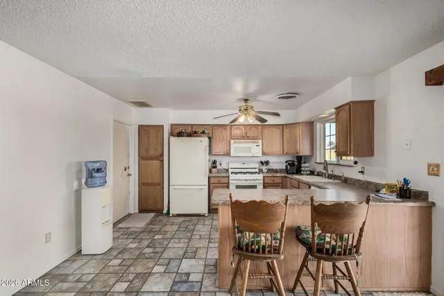 a kitchen with refrigerator and cabinets