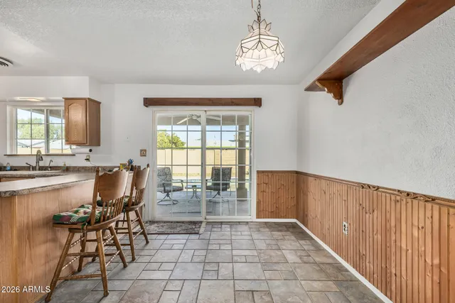 a view of a dining room with furniture and chandelier