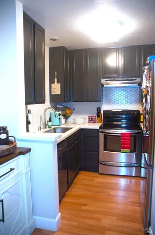 a kitchen with granite countertop stainless steel appliances and wooden cabinets