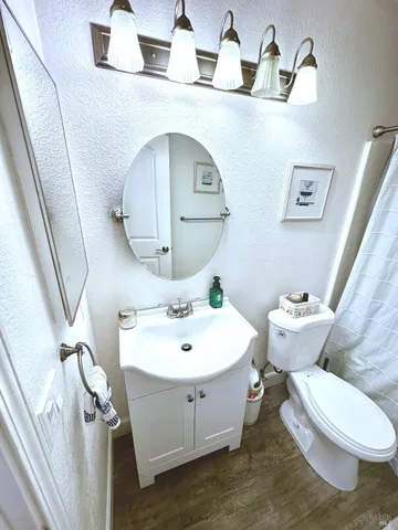 a bathroom with a toilet sink and mirror