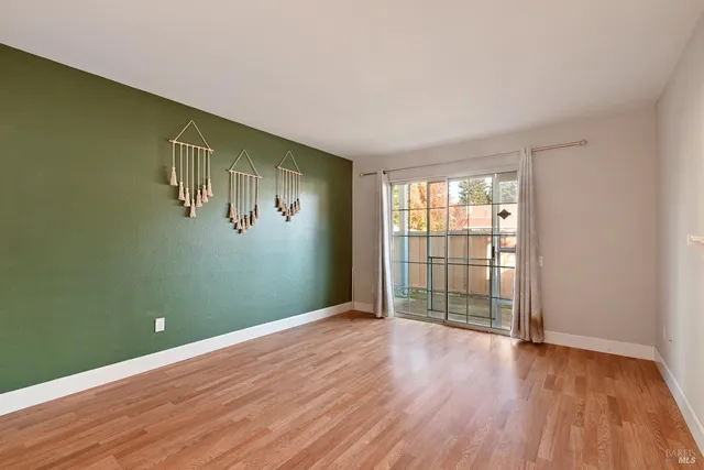 a view of a livingroom with wooden floor and a ceiling fan