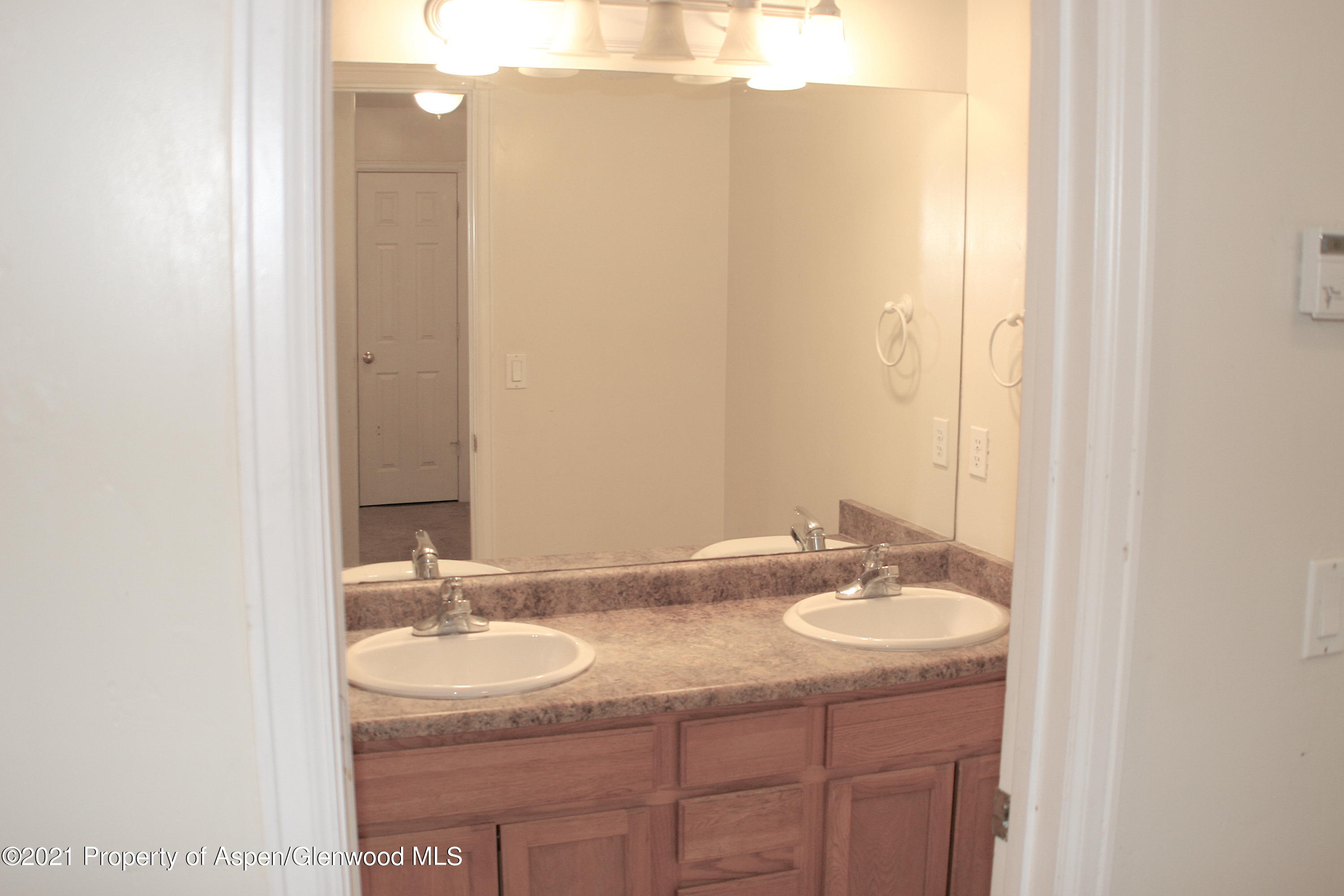 3169 West 31st Court Rifle, CO 81650 - Photo 14 of 27 a bathroom with a sink and a mirror