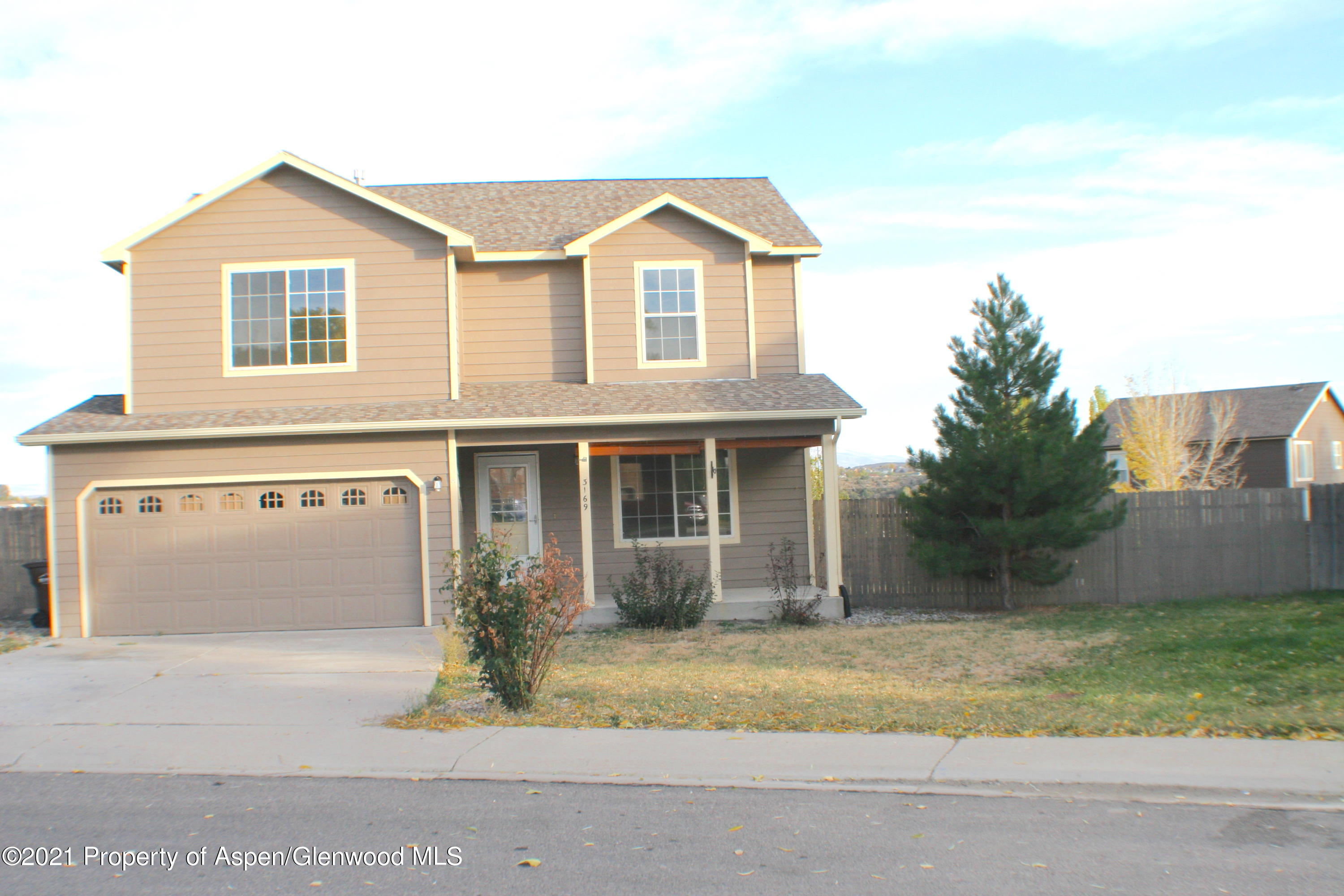 3169 West 31st Court Rifle, CO 81650 - Photo 2 of 27 a front view of a house with a garden and garage