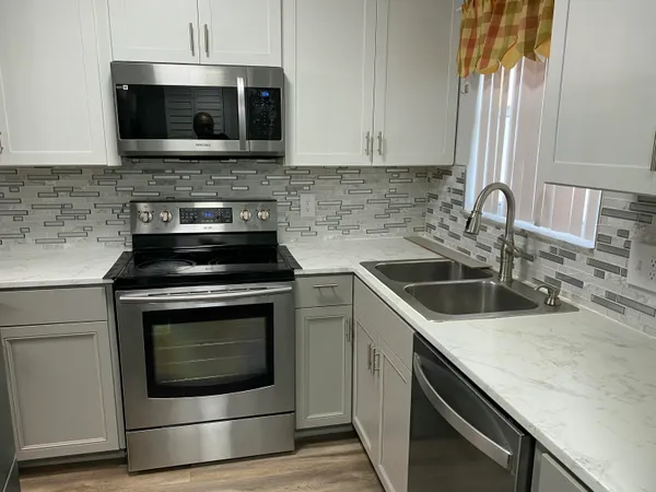 a kitchen with a stove and a microwave