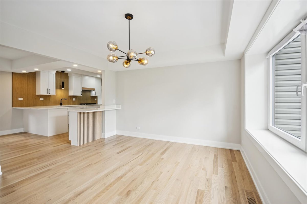 303 Cedarbrook Road Naperville, IL 60565 - Photo 13 of 30 a view of a kitchen with a sink cabinets and wooden floor