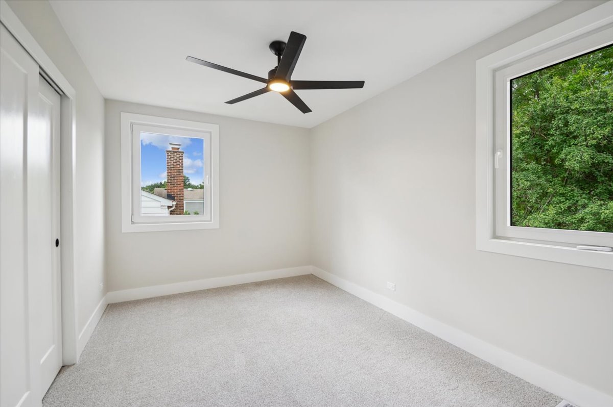 303 Cedarbrook Road Naperville, IL 60565 - Photo 26 of 30 an empty room with windows and fan