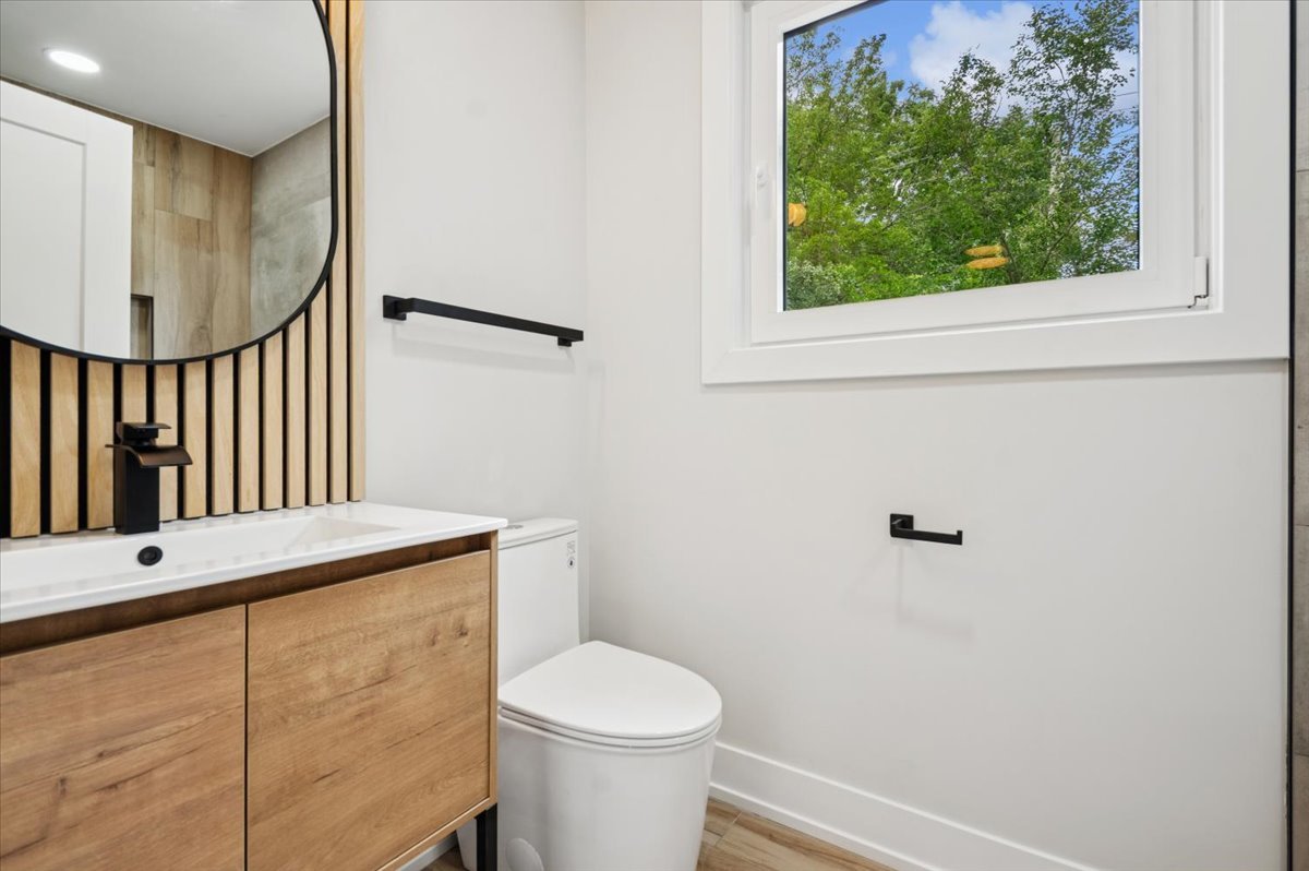 303 Cedarbrook Road Naperville, IL 60565 - Photo 27 of 30 a bathroom with a toilet a sink and a mirror