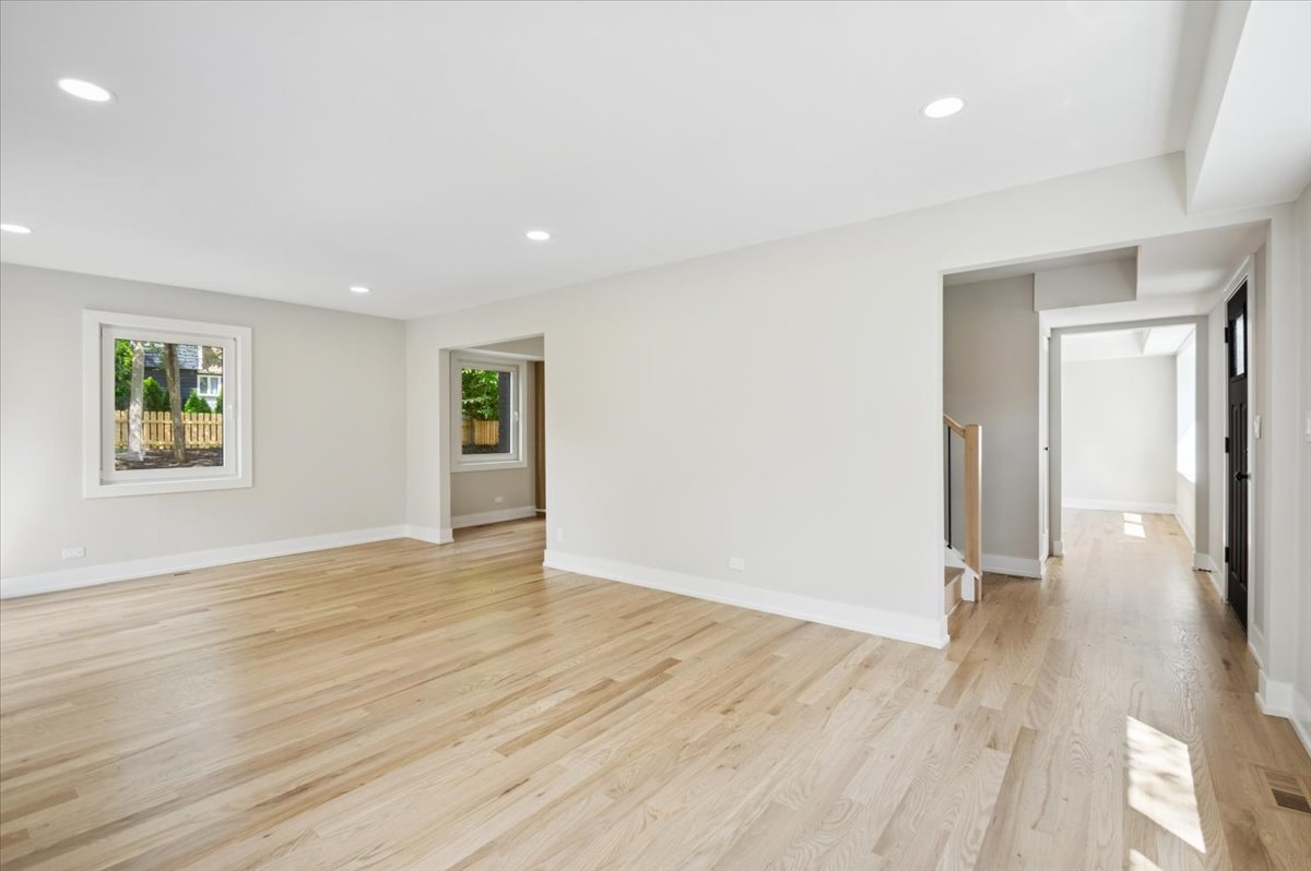 303 Cedarbrook Road Naperville, IL 60565 - Photo 3 of 30 an empty room with wooden floor and a window