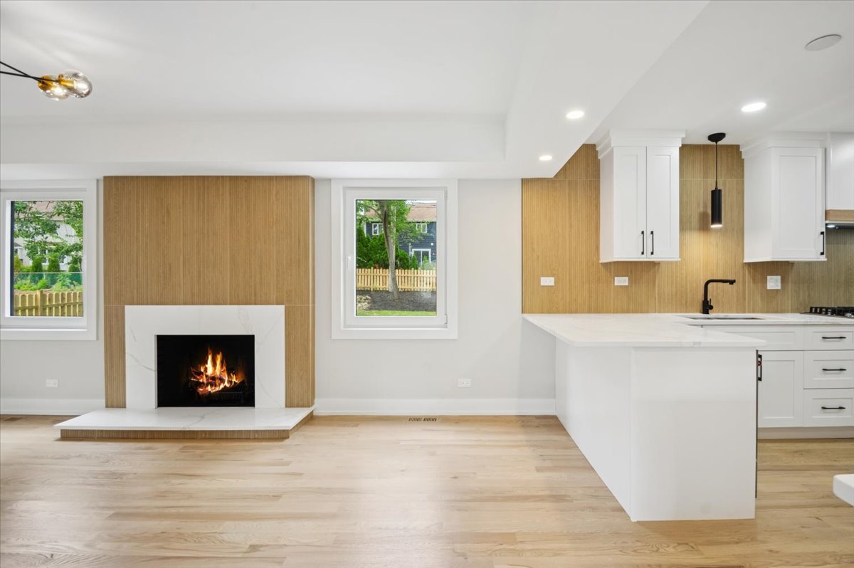 303 Cedarbrook Road Naperville, IL 60565 - Photo 7 of 30 a living room with granite countertop furniture and a fireplace