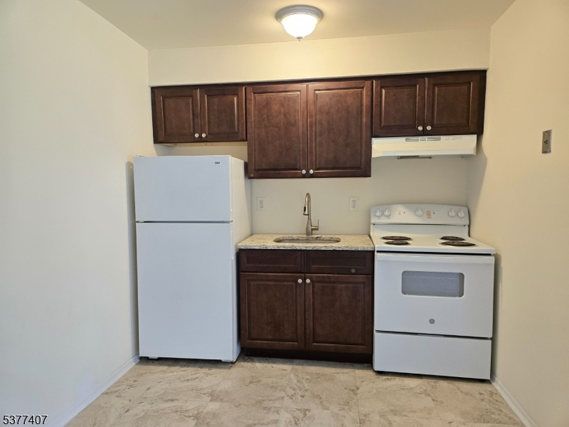 1041 Ridge Street, Unit A 19 Phillipsburg, NJ 08865 - Photo 3 of 20 a kitchen with a cabinets and white appliances