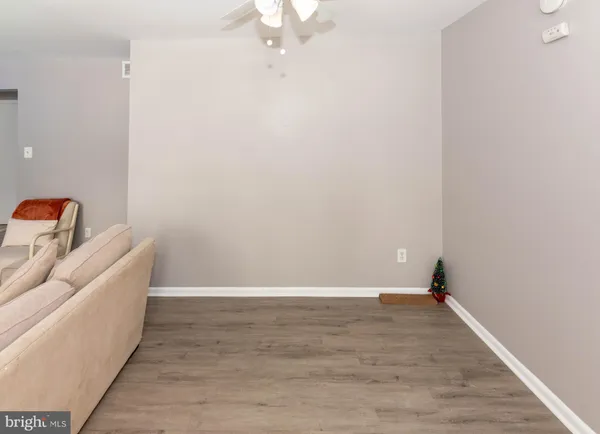a view of a room with wooden floor and fan