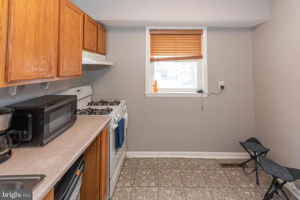 a kitchen with a sink a stove and cabinets