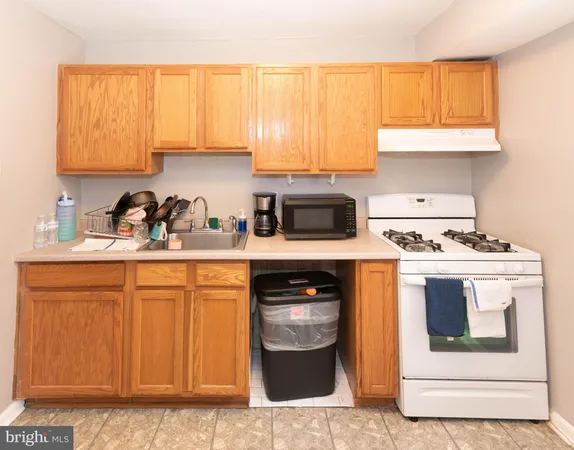 a kitchen with stainless steel appliances granite countertop a sink and a stove