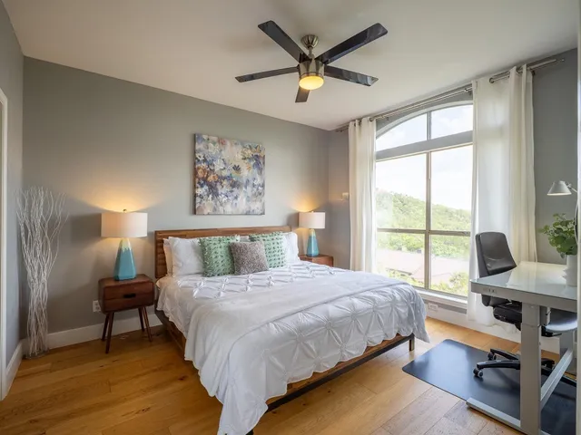 a bedroom with a large bed and a large window