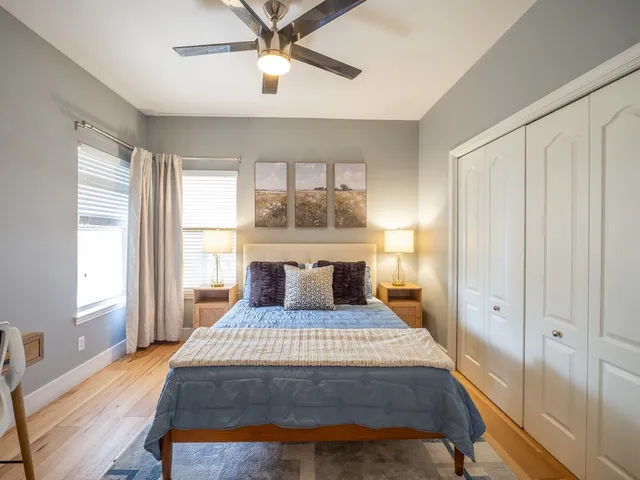 a bedroom with a large bed and a window