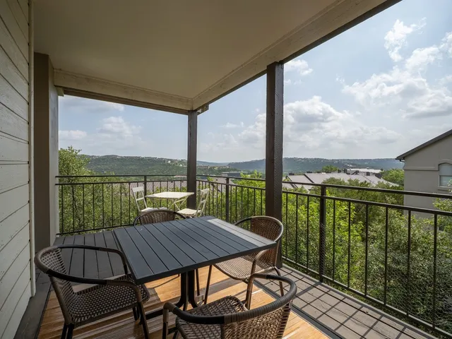 a view of a balcony with couch and wooden floor