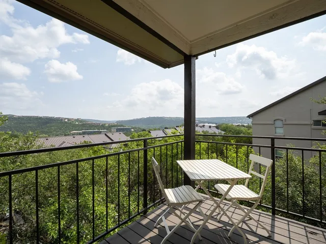 a view of a balcony with lake view and wooden floor