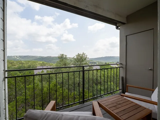 a view of a balcony with wooden floor