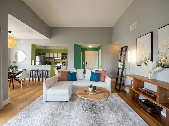 a living room with furniture and a dining table