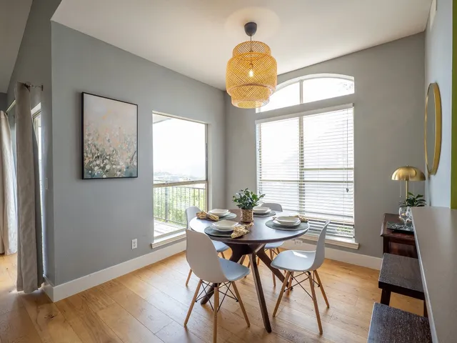 a view of a dining room with furniture a chandelier and wooden floor