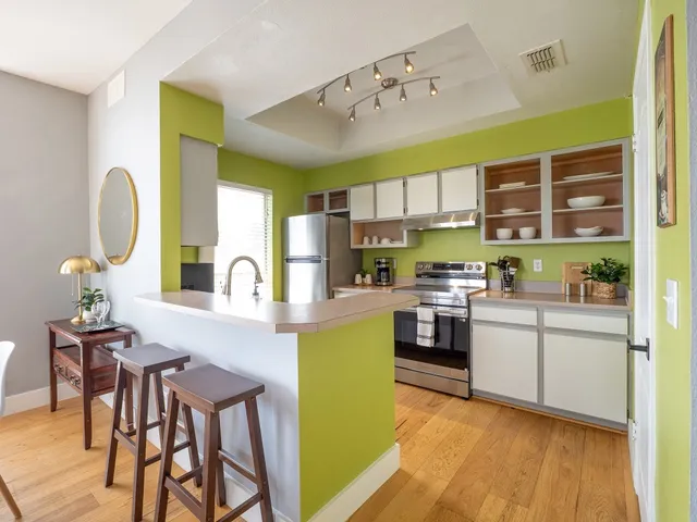 a kitchen with a refrigerator and a stove top oven