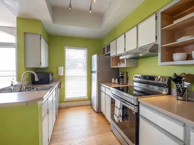 a kitchen with stainless steel appliances granite countertop a sink and a stove