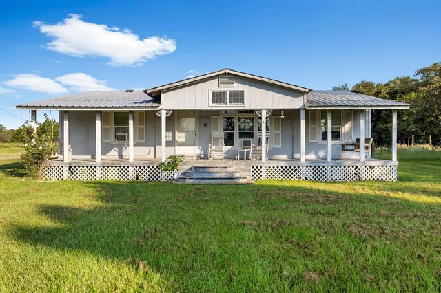 a view of a house with pool and garden