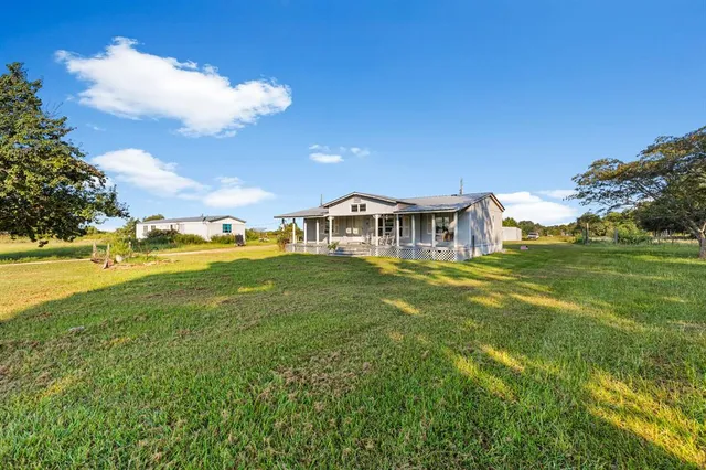 a view of a house with a big yard