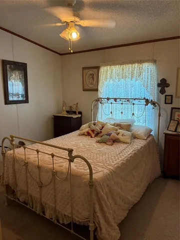 a bed sitting in a bedroom next to a window