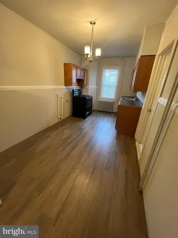 a view of living room with furniture and wooden floor