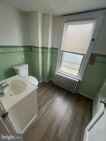 a bathroom with a sink a toilet and tub