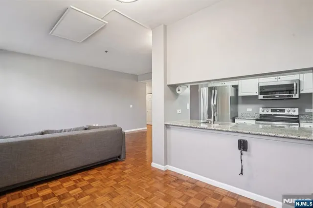 a view of kitchen with stainless steel appliances granite countertop refrigerator sink and stove