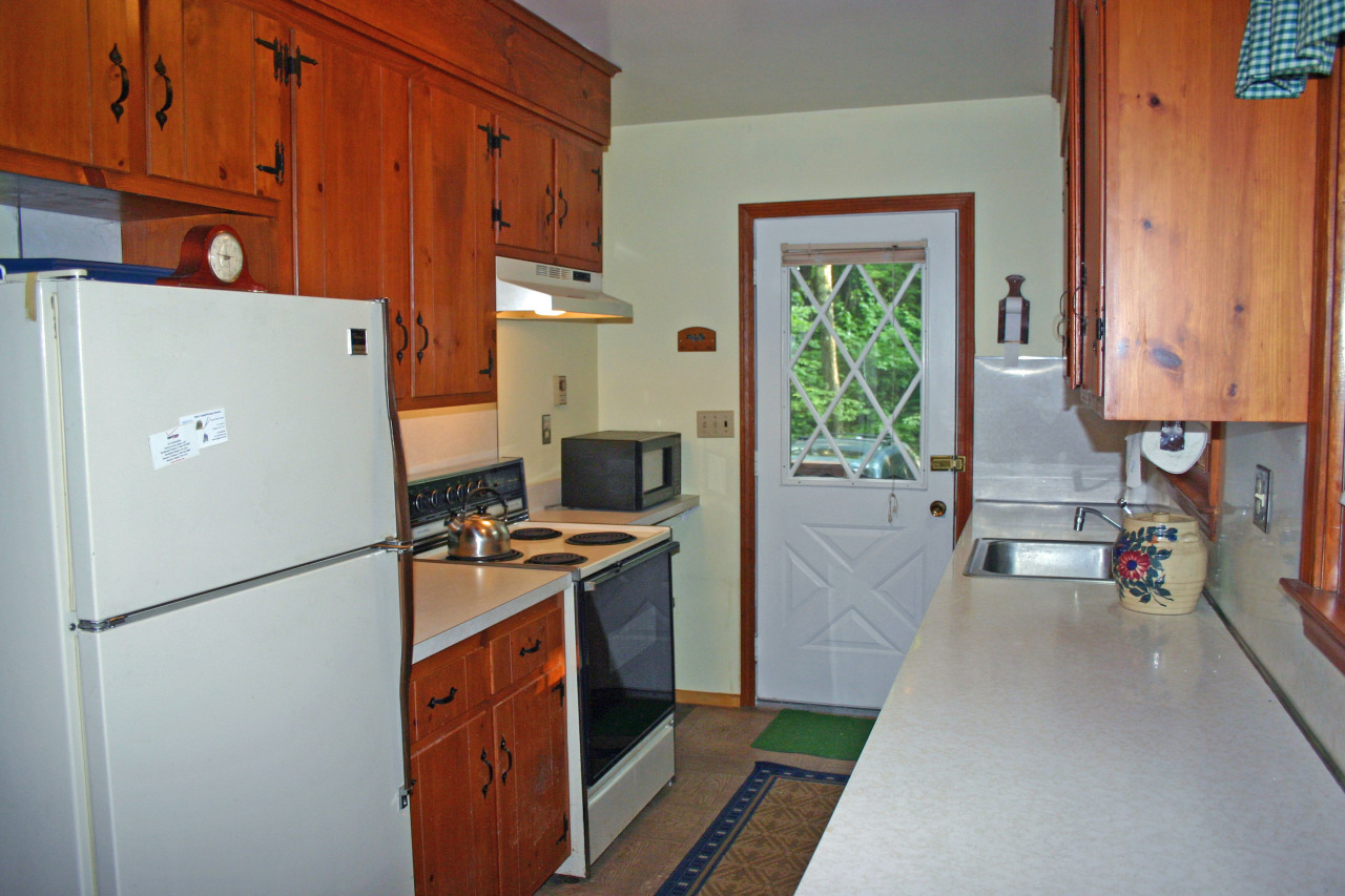 153 Stanley Road Otis, MA 01029 - Photo 12 of 19 a kitchen with stainless steel appliances granite countertop a refrigerator a stove a sink dishwasher and a refrigerator with wooden floor