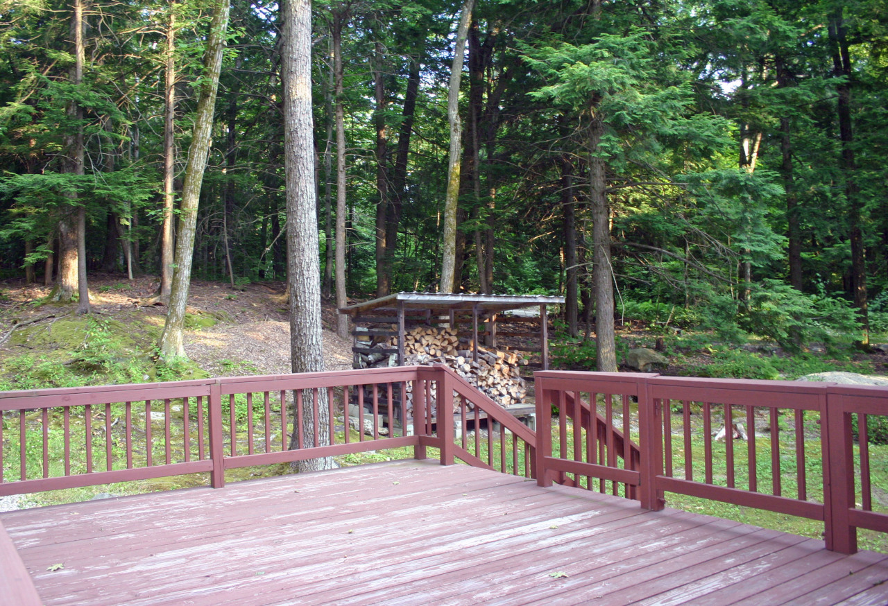 153 Stanley Road Otis, MA 01029 - Photo 4 of 19 a view of a deck with two chair and wooden floor