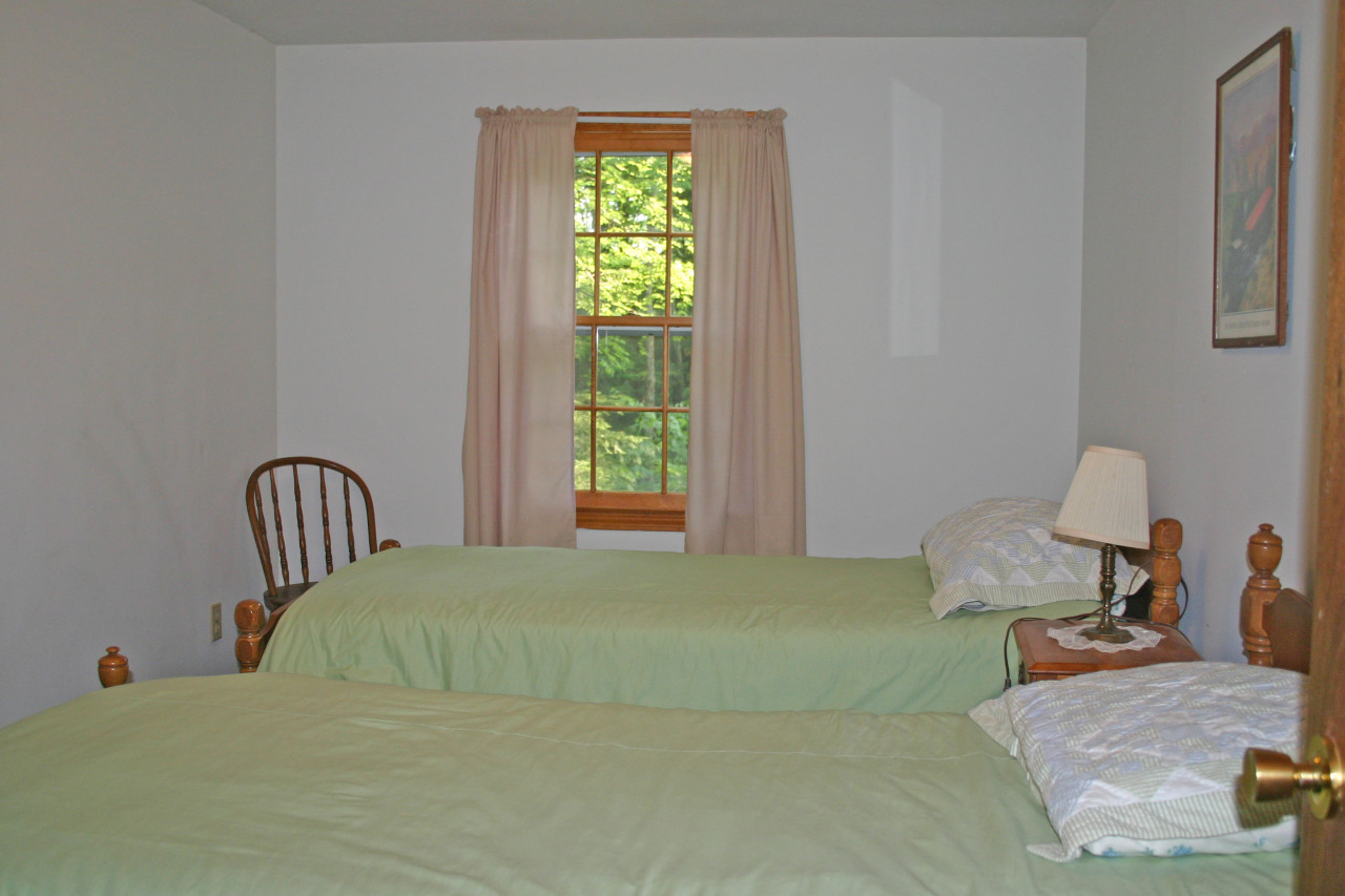 153 Stanley Road Otis, MA 01029 - Photo 5 of 19 a bedroom with a bed chair and two windows