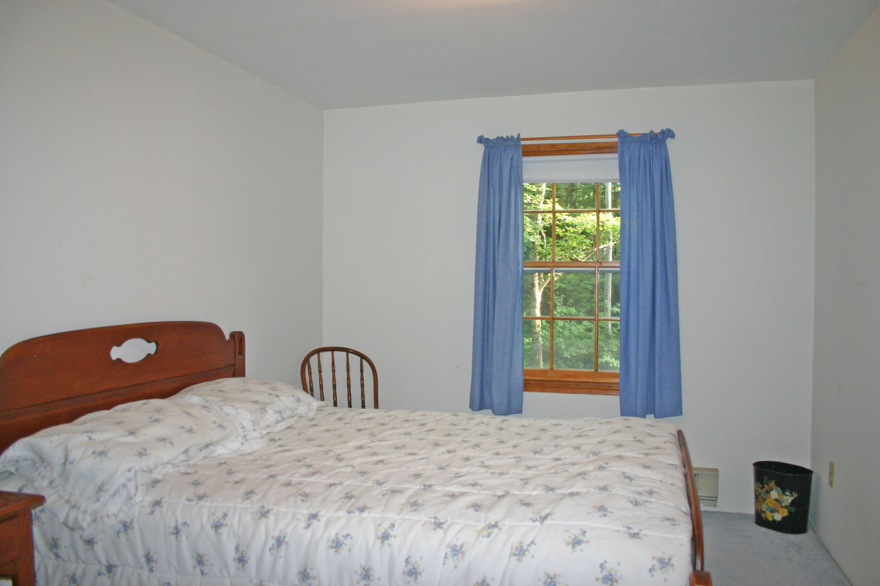 153 Stanley Road Otis, MA 01029 - Photo 6 of 19 a bedroom with a bed and a window