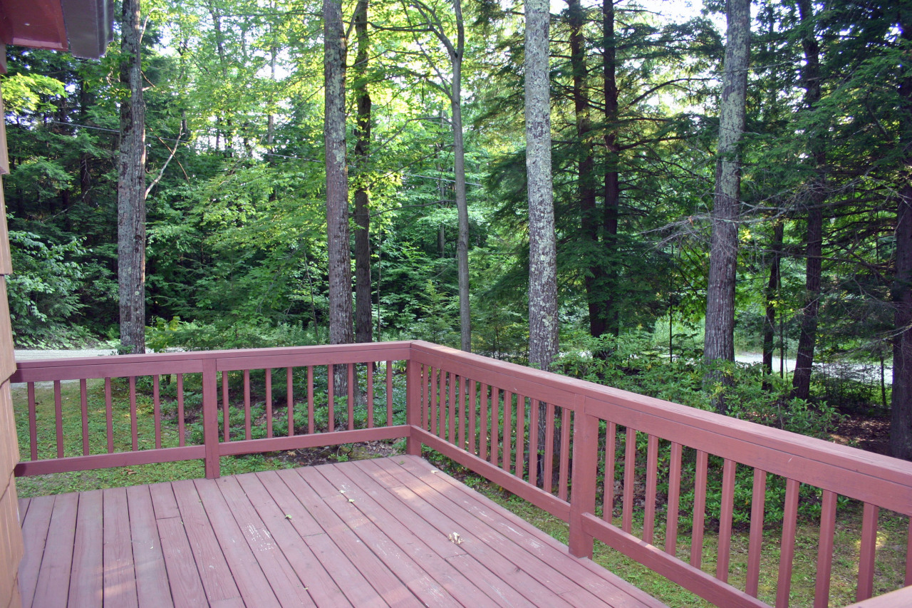 153 Stanley Road Otis, MA 01029 - Photo 9 of 19 a view of balcony with deck and a garden