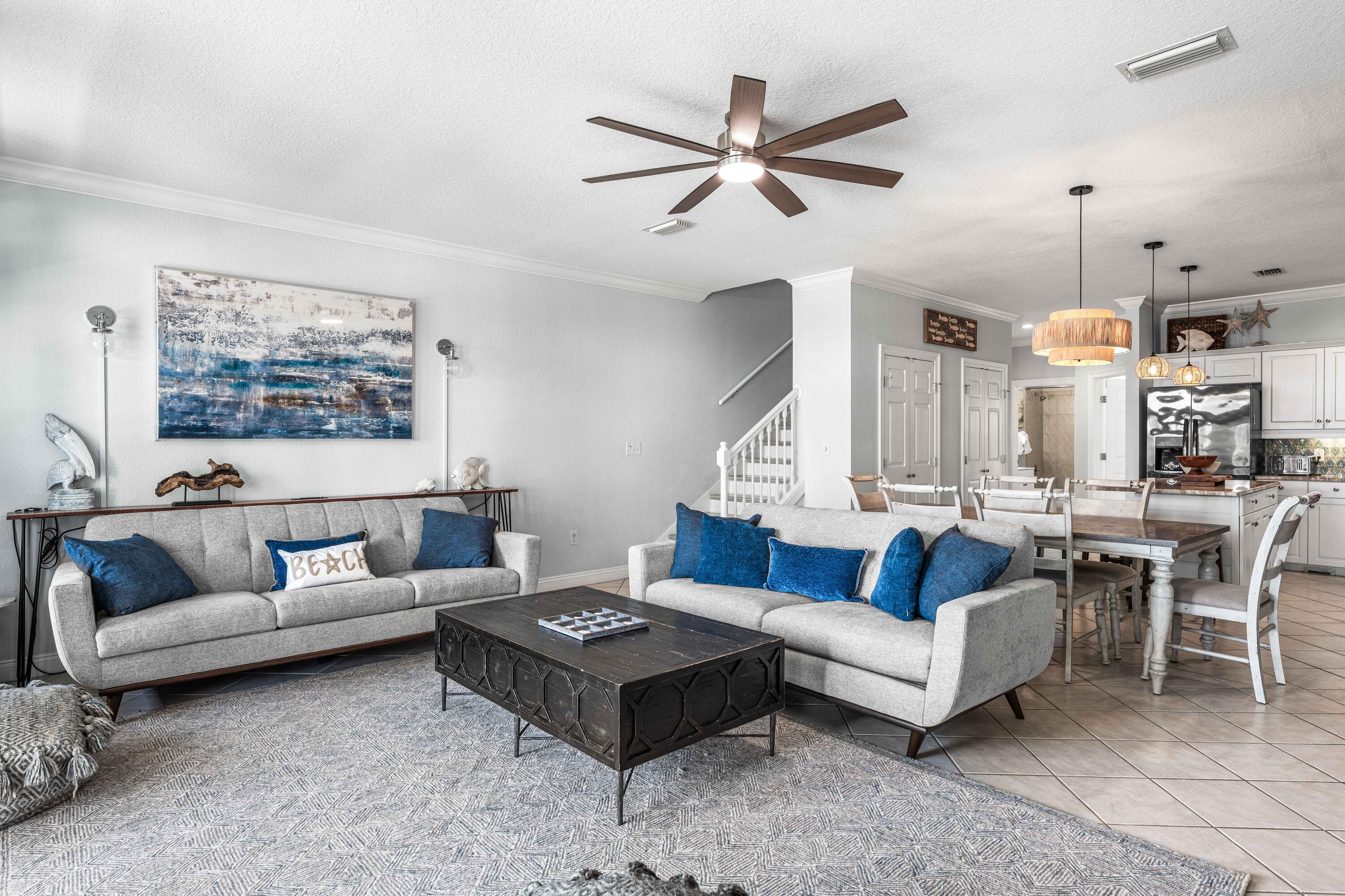 33 Dune Breeze Lane, Unit H2 Santa Rosa Beach, FL 32459 - Photo 3 of 54 a living room with furniture a rug and a chandelier