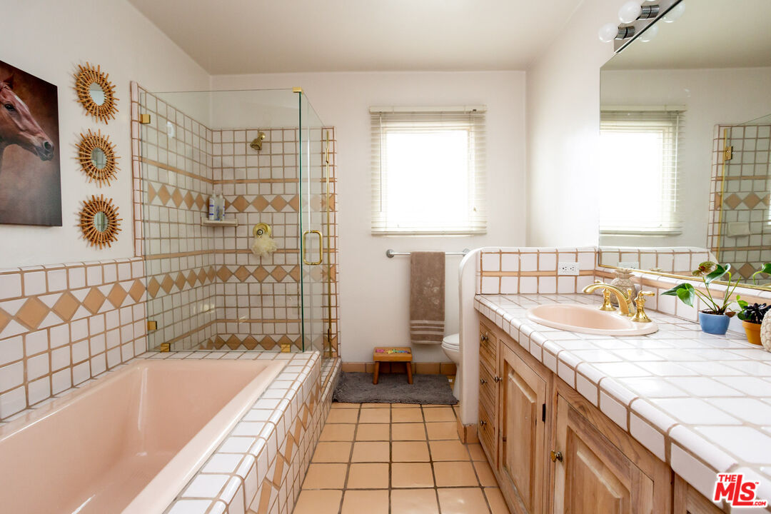 7137 Trask Avenue Playa del Rey, CA 90293 - Photo 20 of 46 a bathroom with a granite countertop sink a toilet and bathtub