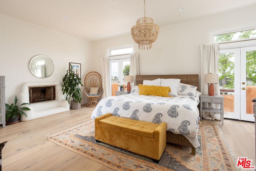 7137 Trask Avenue Playa del Rey, CA 90293 - Photo 24 of 46 a bedroom with a bed and a chandelier